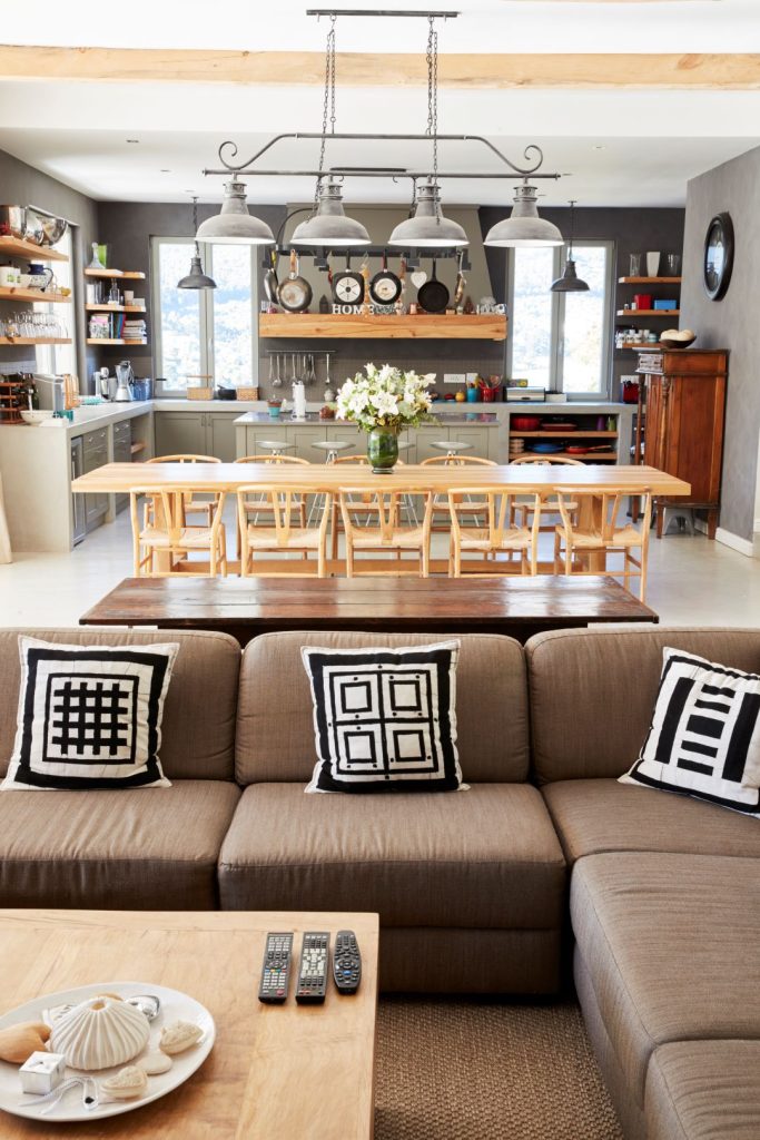 A home remodeling example of an open floor plan seamlessly connecting the kitchen, dining, and living room areas.